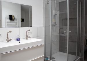 a bathroom with two sinks and a shower at Amselhof Kördorf in Kördorf +60 photos