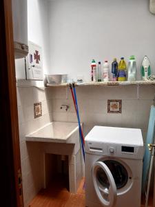 a laundry room with a washing machine and a sink at Casa rural el cerrete in Riópar +22 photos
