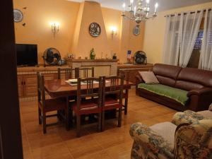 a living room with a table and a couch at Casa rural el cerrete in Riópar