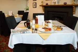 a table with a plate of food on it at The Mansion in Whitehaven