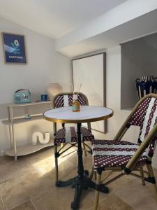 a table and two chairs in a room at Santorin étoilé- hyper centre in Sanary-sur-Mer