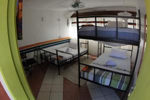 
a room with two beds and a mirror at We Travel Hostel in Moshi
