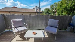two chairs and a coffee table on a patio at JENNAH House in Bussero