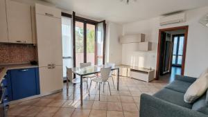 a kitchen and living room with a table and chairs at JENNAH House in Bussero
