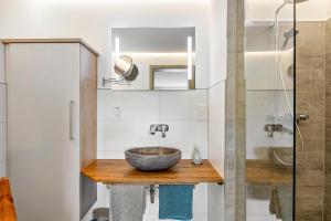 a bathroom with a bowl sink and a shower at Ferienwohnungen Schwarzwaldtraum in Unterkirnach +98 photos