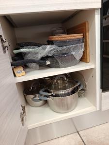 a drawer with pots and pans in a kitchen cabinet at MaraSal in Pozzallo +27 photos