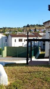 a street light in the grass in front of a building at La Quimera in El Ronquillo