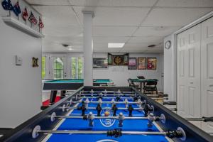 a billiard room with blue tables and ping pong balls at Blue Badger Cottage -Wifi, Fire Pit, Fireplace, Screen Porch, Game Room, King Bed, Grill in Morton Grove