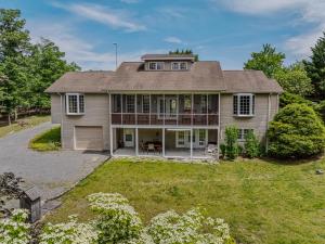 an image of a house with a large yard at Blue Badger Cottage -Wifi, Fire Pit, Fireplace, Screen Porch, Game Room, King Bed, Grill in Morton Grove