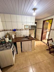 a kitchen with a stove and a sink in it at Chale do Índio - Ilha Grande in Angra dos Reis +22 photos