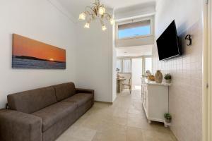 a living room with a couch and a television at L'Aurora Bed and Breakfast in Ugento