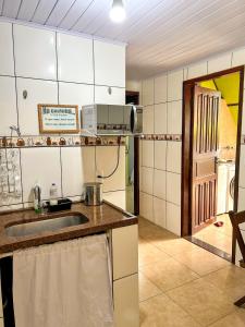 a kitchen with a sink and a counter top at Chale do Índio - Ilha Grande in Angra dos Reis