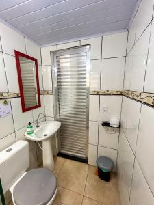 a small bathroom with a toilet and a sink at Chale do Índio - Ilha Grande in Angra dos Reis
