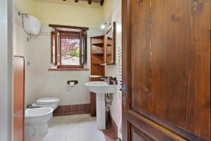 a bathroom with a sink and a toilet and a window at Casolare Sotto le Mura in Anghiari +57 photos