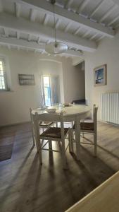 a white table and chairs in a room at Casina Da Vinci in Vinci