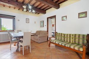 a living room with a table and a couch at Casolare Sotto le Mura in Anghiari