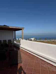 a balcony with a view of the beach at Panoramic Sea View Apartment in Riffiene