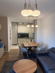 a living room with a table and a blue couch at Resident park apartment in Plovdiv