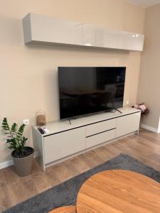 a living room with a large flat screen tv at Resident park apartment in Plovdiv