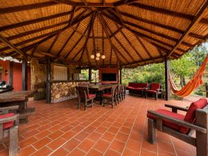 an outdoor patio with wooden tables and chairs at Valle Verde Lodge - Vista in Samaipata