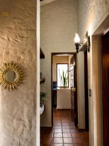 a hallway with a mirror on a wall at Valle Verde Lodge - Vista in Samaipata +7 photos