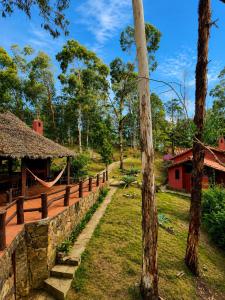 a stone wall and a fence and a tree at Valle Verde Lodge - Vista in Samaipata