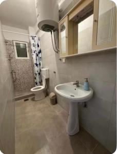 a bathroom with a sink and a toilet at Vista apartments in Risan
