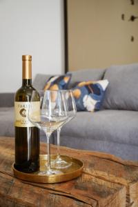 a bottle of wine and two glasses on a table at 7sopot in Buzet
