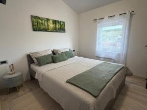 a bedroom with a large bed and a window at 7sopot in Buzet
