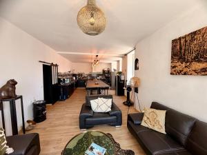 a living room with a couch and chairs and a table at Les Anges de Sigean, Chambres d'hôtes de Luxe,Rooftop Panoramique avec Jacuzzi in Sigean