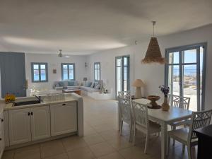 a kitchen and living room with a table and chairs at Minos Villa Antiparos in Antiparos +73 photos