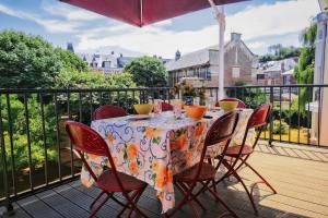 a table with chairs and a tablecloth on a balcony at Villa D'ALBATRE in Dieppe