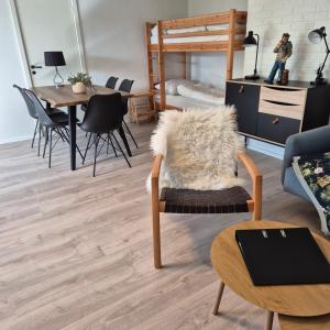 a living room with a chair and a bed at Feriehuse Hvide Sande in Hvide Sande