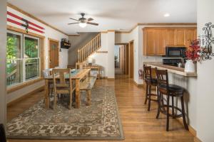 a kitchen with a table and chairs in a room at Lei Lei Mountainstay in Beech Mountain