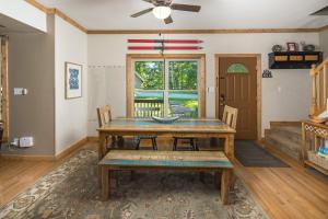 a dining room with a wooden table and chairs at Lei Lei Mountainstay in Beech Mountain