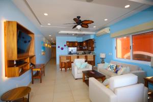 a living room with a couch and a dining room at vivo resort in Chano