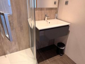 a bathroom with a sink and a shower at Axis Hotel Brussels Airport in Kortenberg +19 photos