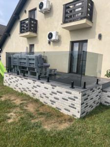 a house with a stone retaining wall with a couch at Cazare Băile Figa -The Home DRM in Beclean +33 photos
