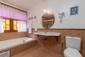 a bathroom with a tub and a sink and a toilet at Pousada das Pedras Paraty -RJ in Paraty +44 photos