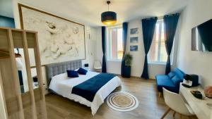 a bedroom with a bed and a couch and a table at Les Anges de Sigean, Chambres d'hôtes de Luxe,Rooftop Panoramique avec Jacuzzi in Sigean +57 photos