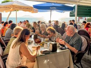 a group of people sitting at a table eating food at Er-öz Hotel & Restaurant in Fethiye
