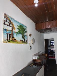 a painting on the wall of a room with a table at Casaraosete7 in Salvador