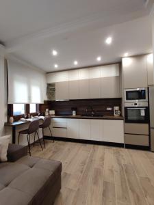 a kitchen with a couch and a table in a room at Evita's House in Doxato