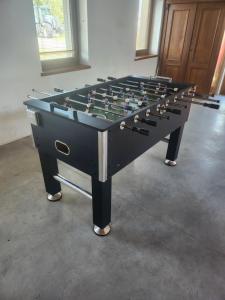 a large black foosball table in a room at Apartmán v Řísnici in Benešov