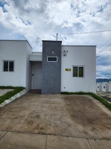 a white building with a parking lot in front of it at Marsella Rest House in Sitio del Niño