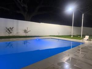 a swimming pool at night with blue illumination at Marsella Rest House in Sitio del Niño