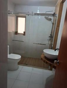 a bathroom with a toilet and a sink at Espaço Acolhedor in Luanda +3 photos