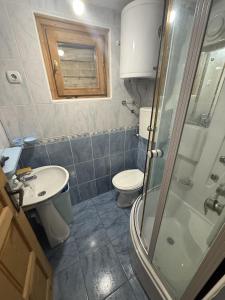 a bathroom with a toilet and a sink and a shower at Vikendica za odmor in Dobra Voda