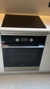 a stove top oven sitting in a kitchen at Acouga in Miñortos
