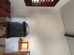 a flat screen tv hanging on a wall at Villa Tarifa Suites in Amontada